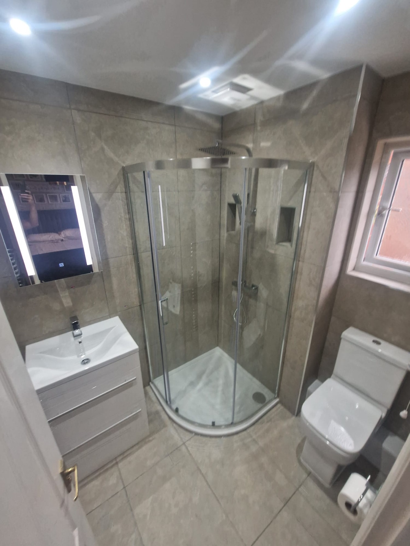 Grey Tiled Bathroom with Curved Shower